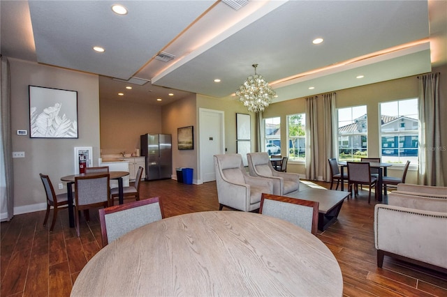 living room with dark hardwood / wood-style flooring and a notable chandelier