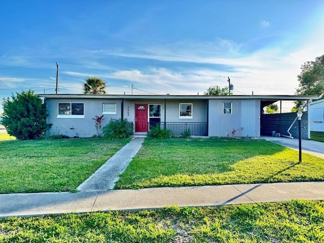 single story home with a front lawn and a carport