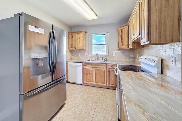 kitchen featuring light tile patterned flooring, sink, white appliances, and decorative backsplash