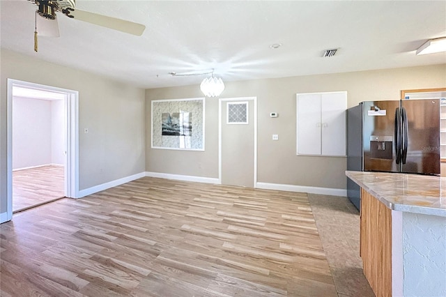 unfurnished dining area with light hardwood / wood-style flooring and ceiling fan