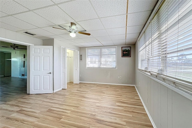 unfurnished bedroom with a paneled ceiling, ceiling fan, and light hardwood / wood-style flooring