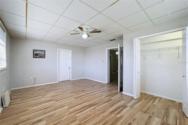 unfurnished bedroom featuring ceiling fan, a paneled ceiling, and light wood-type flooring