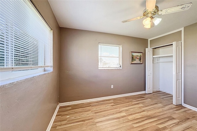 unfurnished bedroom with ceiling fan, light hardwood / wood-style floors, and a closet