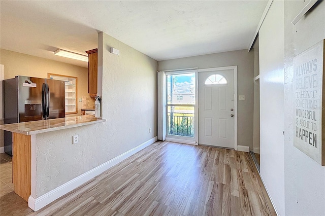 entrance foyer with light hardwood / wood-style flooring