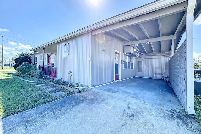 view of property exterior featuring a yard, a carport, and a porch