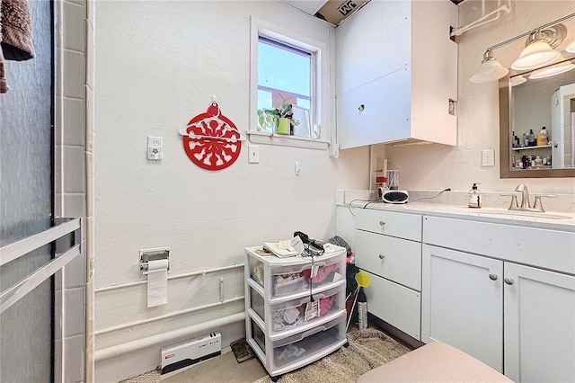 interior space featuring sink and white cabinets