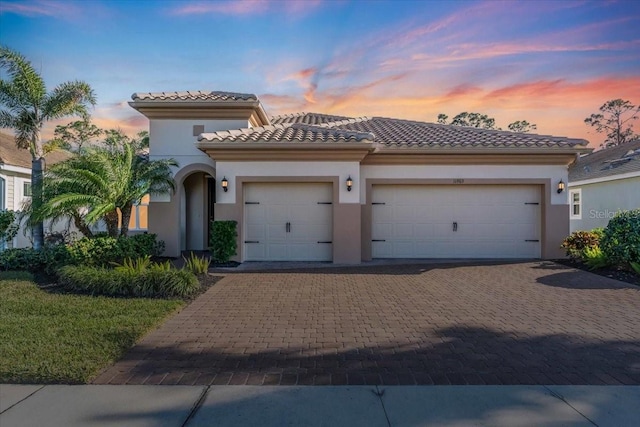 mediterranean / spanish house with a garage