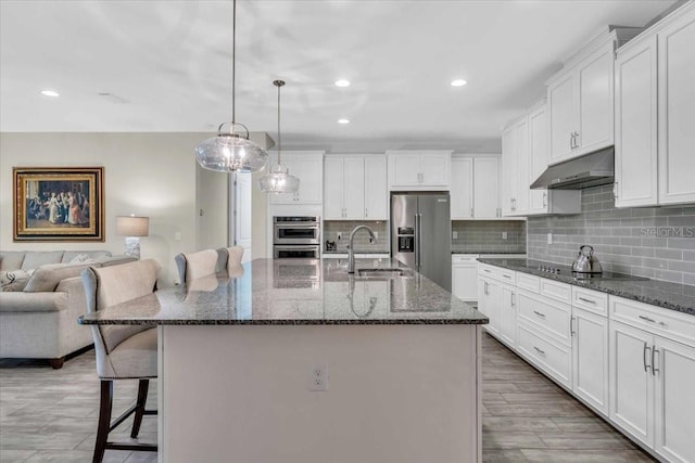 kitchen with sink, a center island with sink, and appliances with stainless steel finishes