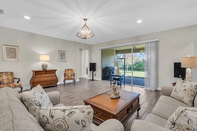 living room with a chandelier and light wood-type flooring