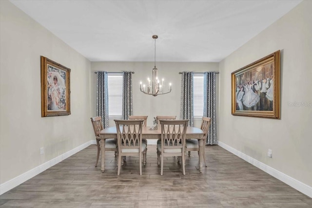 dining room featuring a notable chandelier and hardwood / wood-style floors