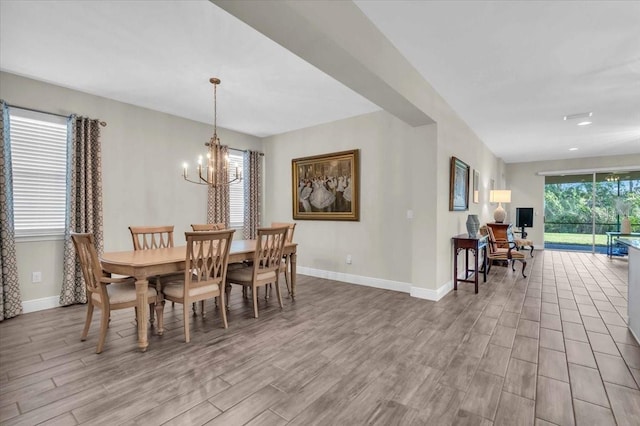 dining area featuring a notable chandelier and light hardwood / wood-style floors