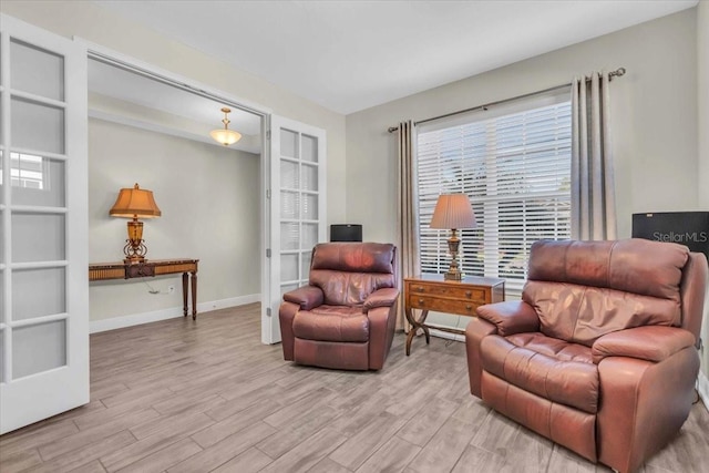 living area with light hardwood / wood-style floors