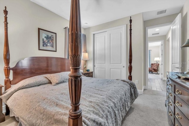 bedroom featuring light carpet and a closet