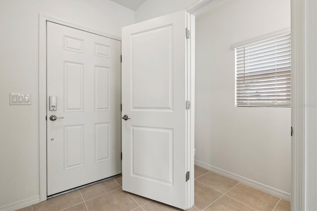 corridor featuring light tile patterned floors