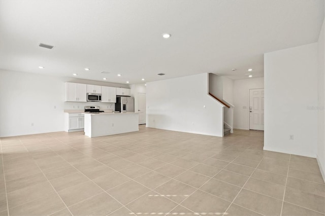 unfurnished living room with light tile patterned floors