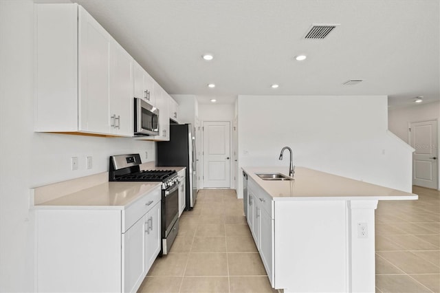 kitchen featuring stainless steel appliances, sink, and white cabinets