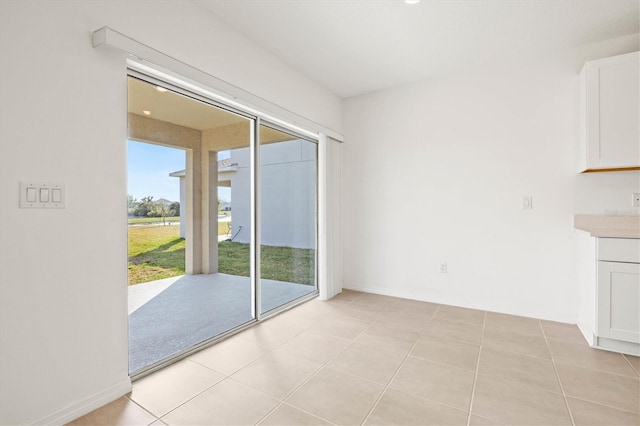 unfurnished dining area with light tile patterned flooring