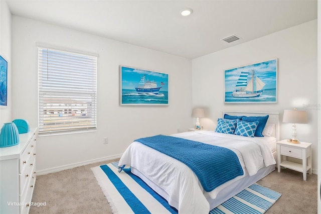 bedroom featuring light colored carpet