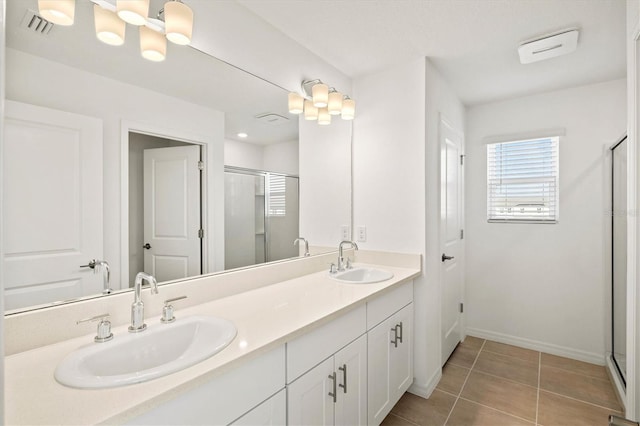 bathroom featuring vanity, an enclosed shower, and tile patterned floors