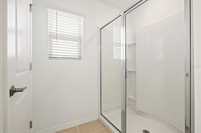 bathroom with tile patterned floors and walk in shower