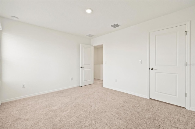 unfurnished room with light colored carpet