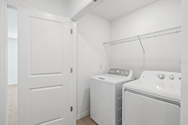 clothes washing area with washing machine and clothes dryer