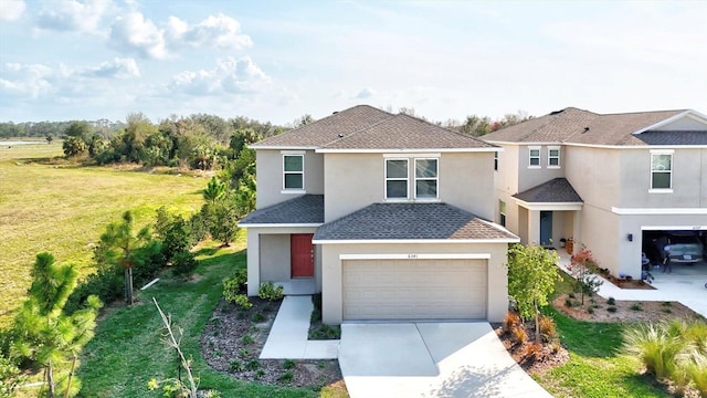 view of property featuring a garage and a front yard