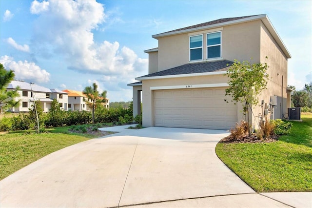 view of front of home featuring a garage, central AC, and a front yard