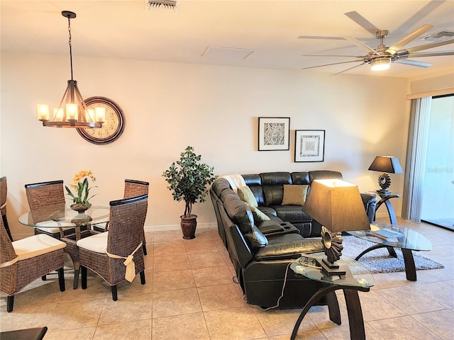 living room featuring ceiling fan with notable chandelier and light tile patterned floors