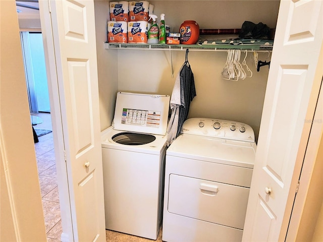 washroom with light tile patterned floors and washer and dryer