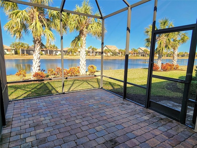 unfurnished sunroom with a water view