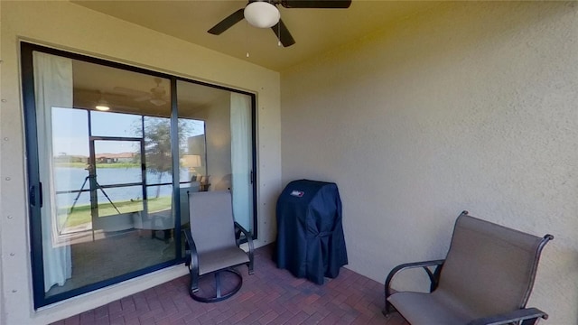 view of patio / terrace with a water view and ceiling fan