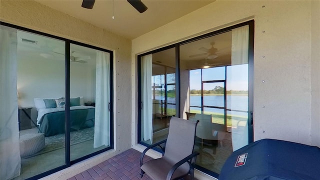 exterior space with a water view and ceiling fan