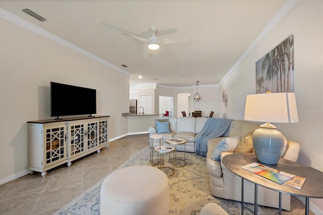 tiled living room with sink, crown molding, and ceiling fan