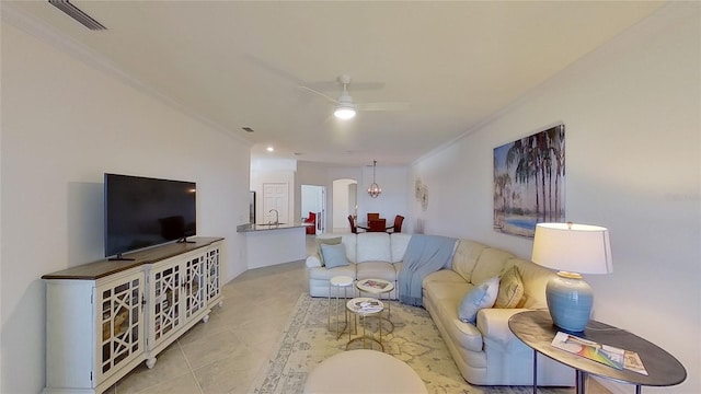 tiled living room featuring ceiling fan and ornamental molding