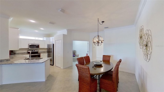 dining area with crown molding, sink, and a notable chandelier