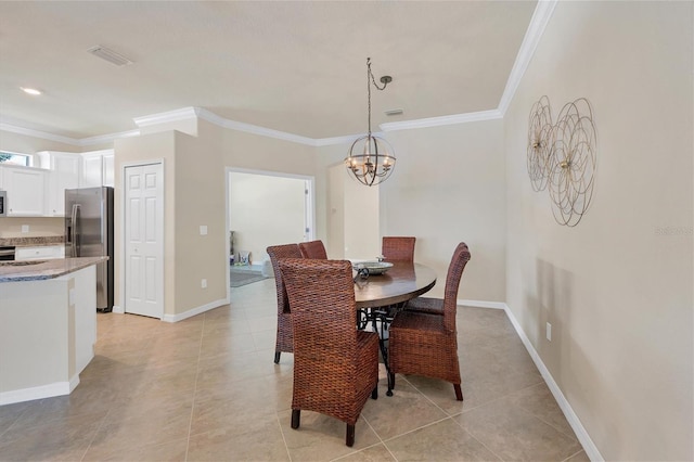 dining space featuring an inviting chandelier, ornamental molding, and light tile patterned flooring