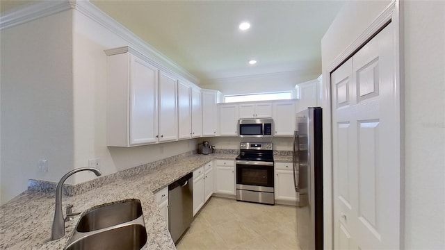 kitchen featuring light tile patterned flooring, appliances with stainless steel finishes, sink, white cabinets, and light stone counters