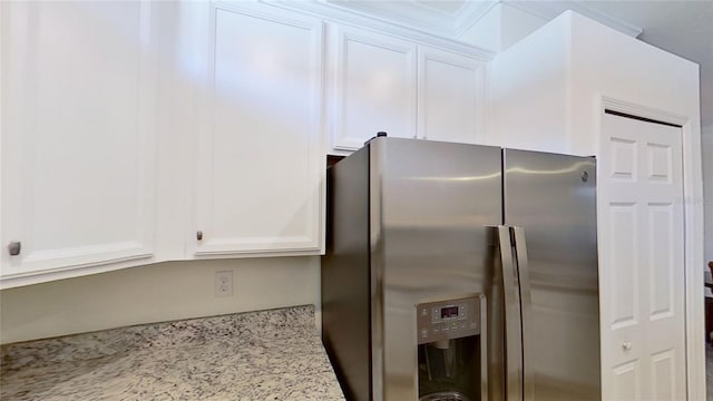 kitchen featuring white cabinetry, light stone countertops, and stainless steel fridge with ice dispenser