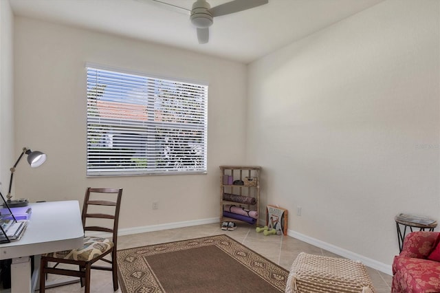 home office with light tile patterned floors and ceiling fan