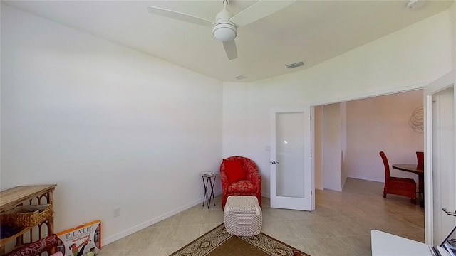 living area featuring french doors, ceiling fan, and light tile patterned floors