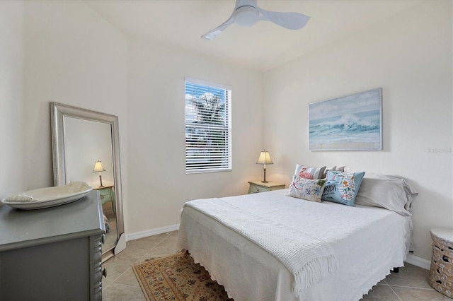 tiled bedroom featuring ceiling fan