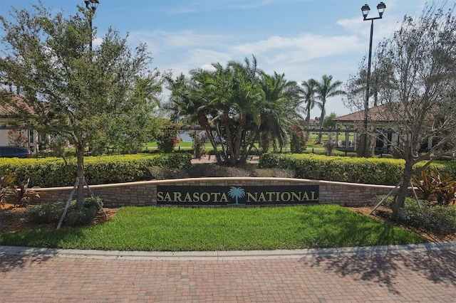 community / neighborhood sign with a lawn