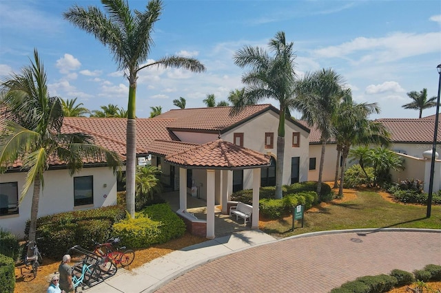 mediterranean / spanish-style house featuring a front lawn