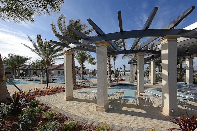 view of pool featuring a hot tub, a pergola, and a patio