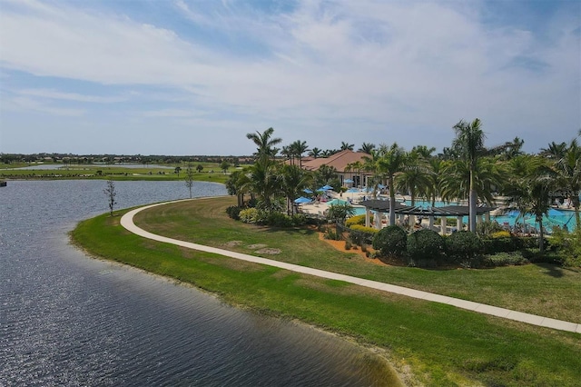 surrounding community featuring a water view and a lawn