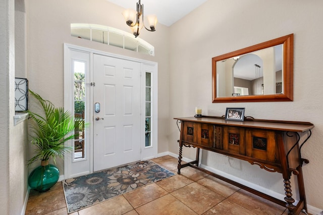 entryway with tile patterned flooring and a chandelier