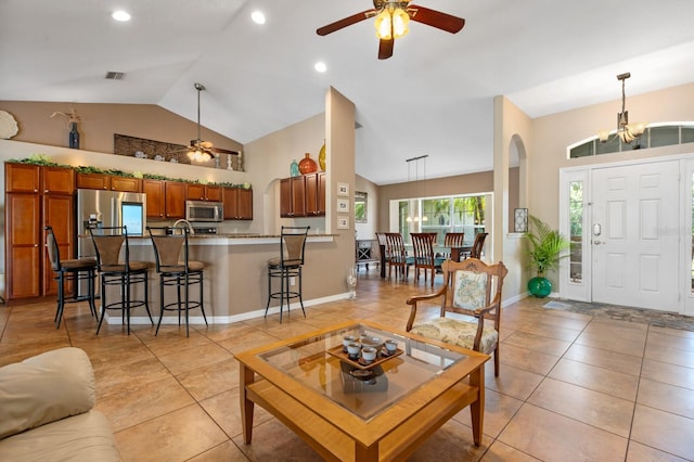 living room featuring light tile patterned flooring, lofted ceiling, and ceiling fan