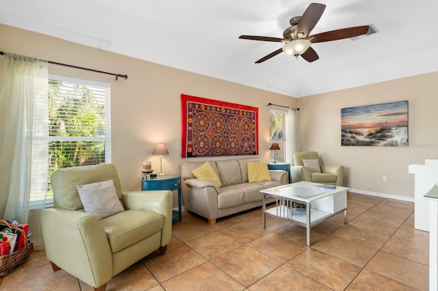 living room with light tile patterned flooring, ceiling fan, and a wealth of natural light