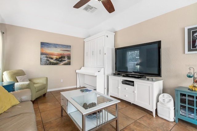 tiled living room with ceiling fan